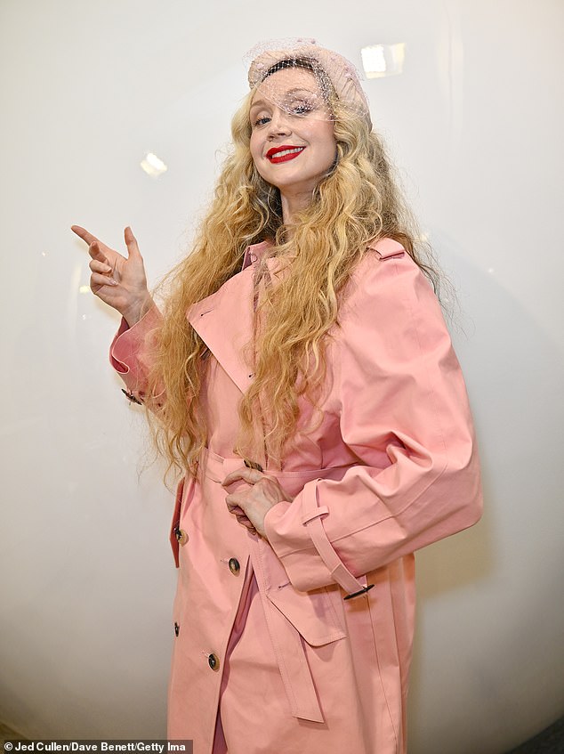 Gwendoline Christie looks stylish in a baby pink trench coat and heels as she attends a Perfect Magazine book signing in London.