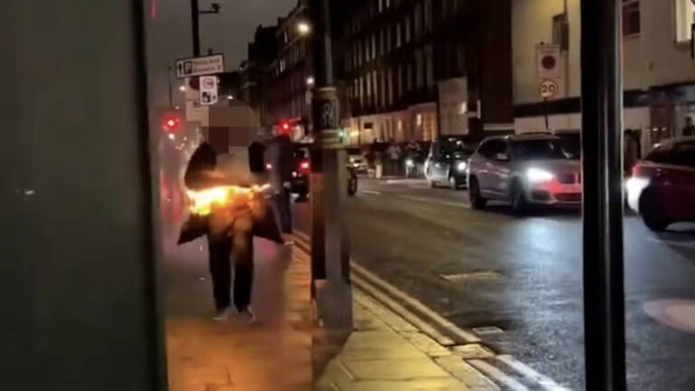 Man lights jumper on fire and charges down London street before shocked onlookers rush in