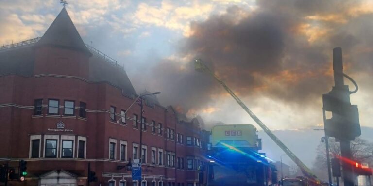 London Forestgate Police Station is on fire, smoke can be seen rising from the roof